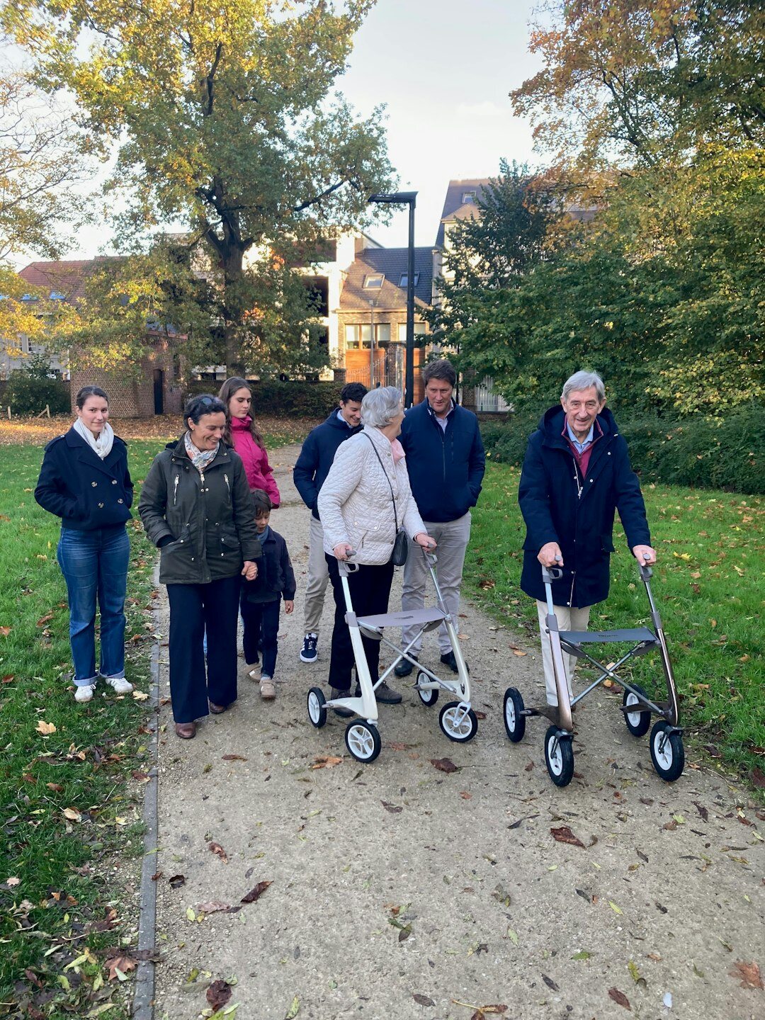 elderly friends walking in park